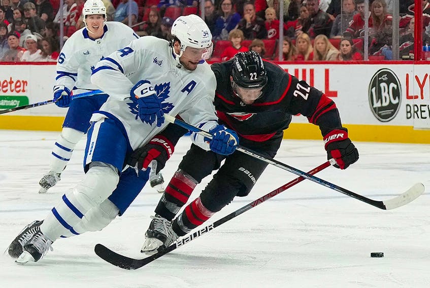Toronto Maple Leafs centre Auston Matthews (34) skates after the puck against Carolina Hurricanes defenceman Brett Pesce (22) at PNC Arena. 