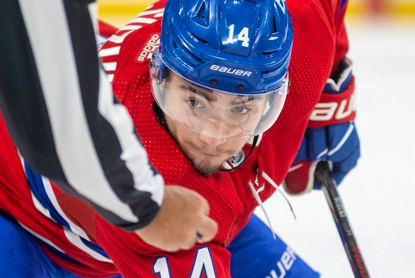 Canadiens' Nick Suzuki concentrates on the linesman's hand as he takes a faceoff during the first period of a National Hockey League game against the New York Rangers in Montreal Thursday March 9, 2023.