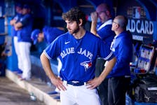 Jordan Romano of the Toronto Blue Jays looks on from the dugout after losing 10-9 to the Seattle Mariners in Game 2 of the American League wild card series at the Rogers Centre on October 08, 2022. 