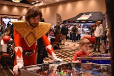 Patrick Boucher as Red Power Ranger plays a game of pinball at the Island Entertainment Expo March 26. Alison Jenkins • The Guardian