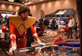 Patrick Boucher as Red Power Ranger plays a game of pinball at the Island Entertainment Expo March 26. Alison Jenkins • The Guardian