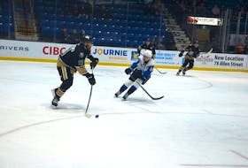 Charlottetown Islanders defenceman Jérémie Biakabutuka, 13, examines his options while controlling the puck in the offensive zone against the Saint John Sea Dogs earlier this season at Eastlink Centre in Charlottetown. Biakabutuka is in his final season of eligibility in the Quebec Major Junior Hockey League (QMJHL).