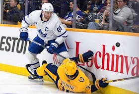 Nashville Predators centre Matt Duchene (95) hits the boards as he goes for a puck against Toronto Maple Leafs captain John Tavares at Bridgestone Arena on Sunday. Tavares had two goals and an assist in the game. 