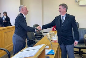Lawyers Geoffrey Spencer (left) and Geoff Budden shake hands in a St. John's courtroom Monday, March 27, 2023, after a Supreme Court of Newfoundland and Labrador judge approved a claims process by which survivors of abuse at Mount Cashel will receive compensation from the Roman Catholic Episcopal Corporation of St. John's. Spencer represents the corporation while Budden represents many of the survivors. TARA BRADBURY • THE TELEGRAM