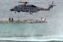 A Sikorsky CH-148 Cyclone refuels in flight off the flight deck of HMCS Montreal in Halifax Harbour in this file photo. The Montreal, supported by a Cyclone team, left for the Indian Ocean on Sunday as part of Operation Projection. - Tim Krochak