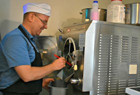 Ken Meister, the owner of Holman's Ice Cream Parlour, pours freshly made ice cream into a tub. – Desiree Anstey
