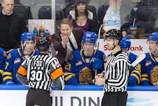 Edmonton Oil Kings head coach Luke Pierce converses with officials in a game against the Swift Current Broncos at Rogers Place in Edmonton on Dec. 16, 2022. The Broncos won 8-4.