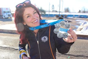 Kim Bailey holds up her Six Stars Medal from the Abbott World Marathon Majors. The medal was given to her for competing the big-six marathons. George Melitides • The Guardian
