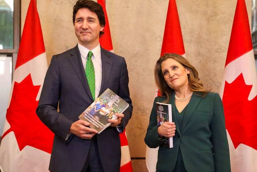 Prime Minister Justin Trudeau and Finance Minister Chrystia Freeland speak to the media, holding the 2023-24 budget, on Parliament Hill in Ottawa, on March 28.