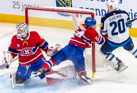 Canadiens' Jordan Harris slams into the post during a game in January. “I was surprised how often you get hit in the face," he says about not wearing a protective cage in the NHL like he did in college. "It was multiple times every game."