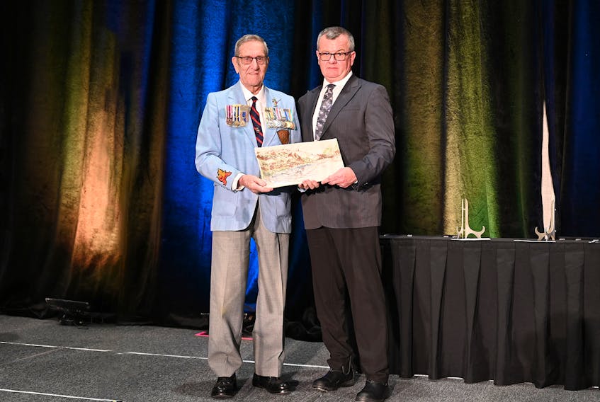 Doug England, left, is presented his Applause Award for senior of the year by St. John's Coun.Carl Ridgeley at the St. John's Convention Centre on March 28. Contributed