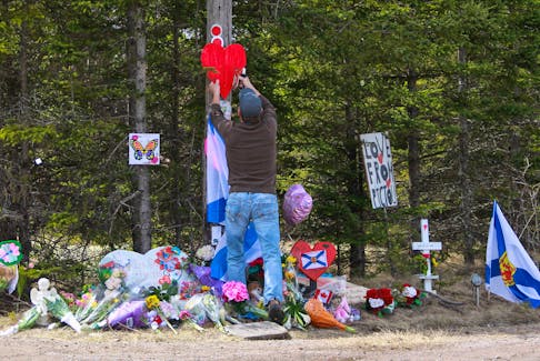 A man staples a heart to a utility pole  at the the makeshift memorial, made in the memory for the victims of Sunday’s mass shooting in Portapique, Nova Scotia, Canada April 23, 2020. REUTERS/Tim Krochak  A man staples a heart to a utility pole at the makeshift memorial, made in memory of the victims of Sunday’s mass shooting in Portapique, N.S., on April 23, 2020. - tTim Krochak / Reuters