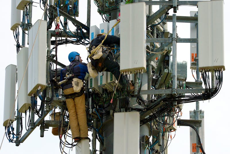 Two workers perform maintenance in a sea of wires at the top of a cell tower in Mount Pearl in May 2021. TELEGRAM FILE PHOTO