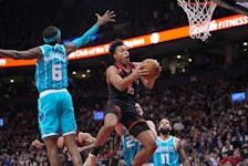 Toronto Raptors forward Scottie Barnes (4) goes up to make a basket against Charlotte Hornets forward Jalen McDaniels on Thursday. 
