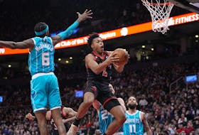 Toronto Raptors forward Scottie Barnes (4) goes up to make a basket against Charlotte Hornets forward Jalen McDaniels on Thursday. 

