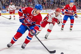 Canadiens' Mike Matheson tries to control a rolling puck under pressure from Hurricanes' Andrei Svechnikov during a game in early March at the Bell Centre.