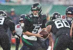 Nov 27, 2022; East Rutherford, New Jersey, USA; New York Jets quarterback Mike White hands the ball off during the second half against the Chicago Bears at MetLife Stadium. 