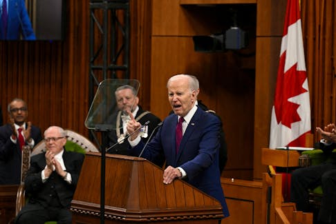President Joe Biden addresses Canadian MPs who initially remain seated during a standing ovation for Biden’s remarks on gender equality: “Even if you don’t agree, guys, I’d stand up,” he said in Parliament on March 24, 2023.  - Kenny Holston/Pool via REUTERS