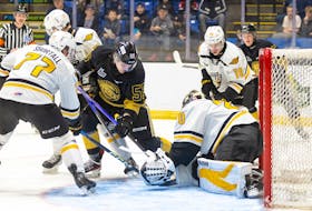 Charlottetown Islanders forward Simon Hughes, 55, of Stratford attempts to jam a rebound home against Cape Breton Eagles goaltender Oliver Satny, 20, who receives support from defenceman Conor Shortall, 77, and forward Luke Patterson, 10. The action took place during a Quebec Major Junior Hockey League (QMJHL) game at Eastlink Centre in Charlottetown recently. Darrell Theriault Photo • Courtesy of Charlottetown Islanders
