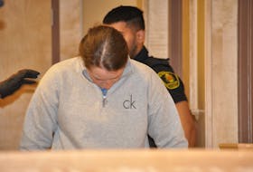 Noelle Laite keeps her head down as she enters the Supreme Court of Newfoundland and Labrador in Corner Brook on Thursday, March 30. Laite has been released on bail pending her appeal of her conviction and sentence on charges of assaulting her former intimate partner. - Diane Crocker/SaltWire Network