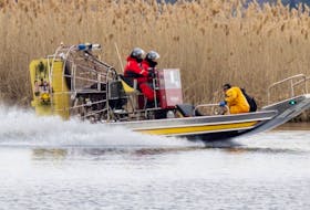 An air boat from the Akwesasne fire service joins the search for drowning victims in a marsh in Akwesasne on Friday.