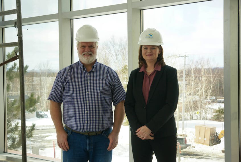 SONY DSC  Mark Griffin, left, board chairman of Lionel Kelland Hospice, and Peggy Hamilton, right, executive director, oversee construction of the new building. - R. Daley