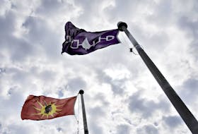 The Mohawk and Five Nations flags fly 