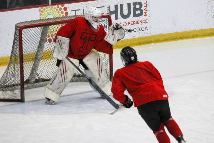 Truro Bearcats goaltender Jack Milner and defenceman Brendan Bays in a drill during their Friday afternoon practice.