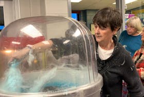 Louann Link was kept busy making cotton candy at a charity hockey game at the Sandy Wickens Memorial Arena on March 25 in support of the Jevon Link Let Your Light Shine Society, started in memory and honour of her son.  KATHY JOHNSON