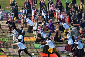 People take part in a yoga training session at a university in Lahore, Pakistan on Feb. 26, 2023.