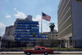 A vintage car passes by the U.S. Embassy in Havana in 2021.