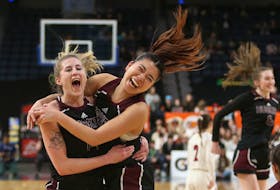 Saint Mary's Huskies, Lucina Beaumont and Kobayashi Aki and celebrate their 68-56 victory over the Acadia Axewomen to take the AUS womens bball title in Halifax Sunday February 26, 2023.

TIM KROCHAK PHOTO