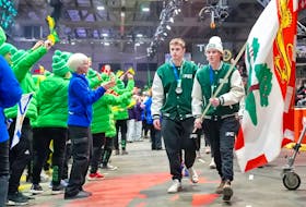 Team P.E.I. flag bearers Lucas MacDonald, left, and Arden Hopkin lead the province's contingent during the parade of athletes at the 2023 Canada Winter Games closing ceremony. Rudi Terstege • Special to SaltWire Network