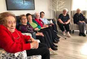 From left, Alderwood Retirement Centre residents Nora Normore, Teresa Bowen, Margaret Vickers, Alice Kavanagh, Betty Sutton, Verlie Winter and Kay Smith gather in a sitting room at the Witless Bay facility Tuesday, March 7, to talk about a video they made to mark International Women's Day. (Peter Jackson/The Telegram)