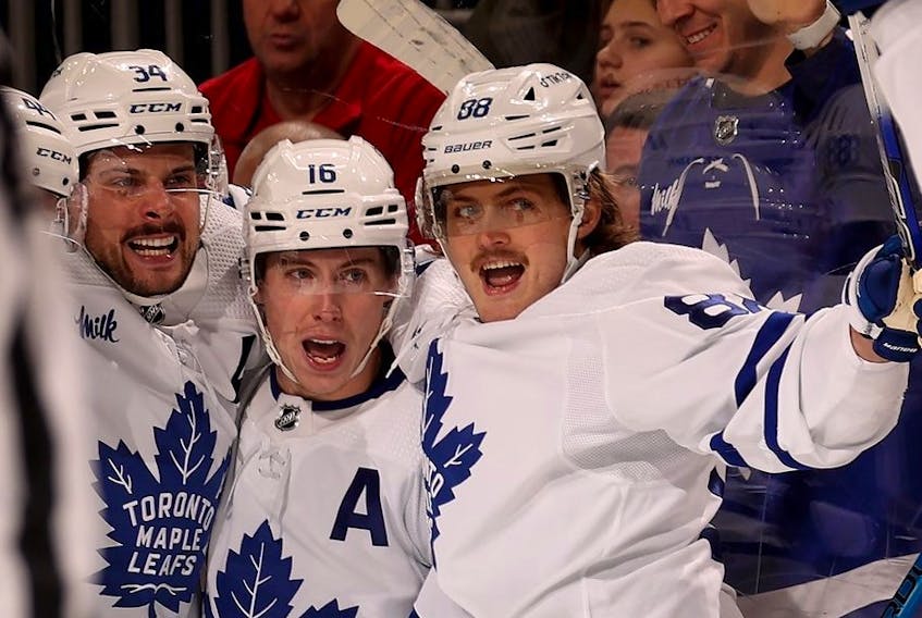 Auston Matthews of the Toronto Maple Leafs is congratulated by teammates Mitchell Marner and William Nylander after Matthews scored the game winning goal during the third period against the New Jersey Devils at Prudential Center on March 07, 2023 in Newark, New Jersey.  
