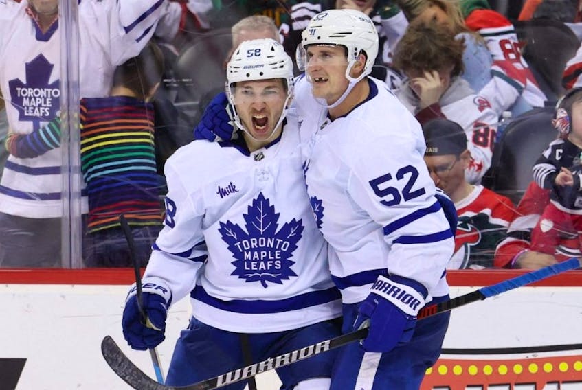 Maple Leafs left wing Michael Bunting (left) celebrates his goal with Noel Acciari during the third period against the Devils at Prudential Center in Newark, N.J., Tuesday, March 7, 2023.