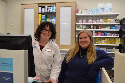 Ashley McMullin, a pharmacist, left, is pictured with Megan Sharpe, a registered technician, at the Shoppers Drug Mart pharmacy in Glace Bay. "I'm up to date on all my vaccinations thanks to Shoppers Drug Mart," said McMullin. SHANNON LEE/CAPE BRETON POST