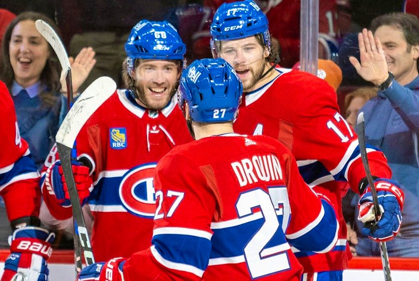 Montreal Canadiens' Mike Hoffman, left, celebrates his first-period goal with teammates Josh Anderson and Jonathan Drouin during game against the Carolina Hurricanes in Montreal on March 7, 2023.