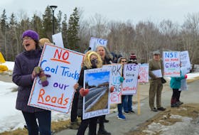 Catherine Fergusson, chair of the Cow Bay Environmental Coalition, leads a group of supporters during a rally outside of Sydney office of the provincial Department of the Environment and Climate Change on Upper Prince Street. IAN NATHANSON/CAPE BRETON POST