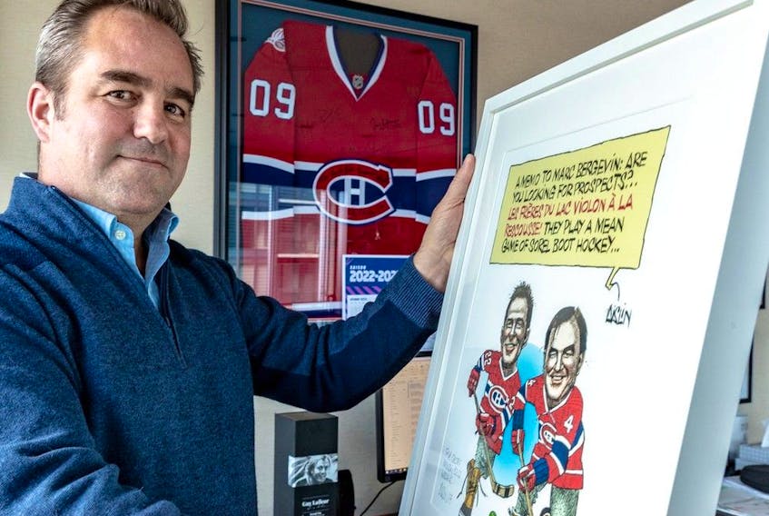 Canadiens owner/president Geoff Molson poses with a framed cartoon by the Montreal Gazette’s Terry Mosher (Aislin) in his office on seventh floor of the Bell Centre.