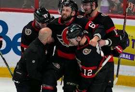 Ottawa Senators' Shane Pinto, Alex DeBrincat and Austin Watson help carry injured teammate Derick Brassard off the ice during second period NHL action, against the Philadelphia Fylers Thursday, March 30, 2023 in Ottawa.
