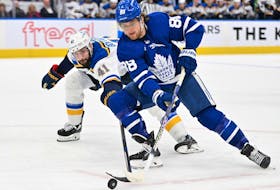 Toronto Maple Leafs forward William Nylander moves the puck past St. Louis Blues defenseman Robert Bortuzzo in the third  period at Scotiabank Arena.  