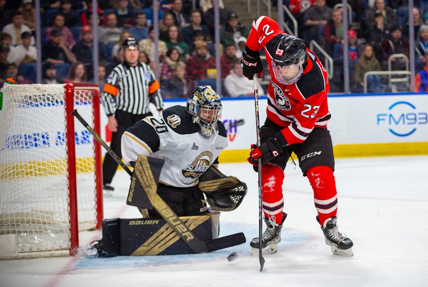 Quebec Remparts forward Davis Cooper, 23, attempts to redirect a shot on Charlottetown Islanders goaltender Jakob Robillard during Game 1 of the best-of-seven Quebec Major Junior Hockey League (QMJHL) playoff series in Quebec City on March 31. Quebec won the contest 3-0. Photo Courtesy of Quebec Remparts • Special to The Guardian
