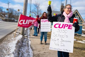 Cape Breton-Victoria Regional Centre for Education cleaner Darlene Sullivan, right, and teacher aid Mallory Axworthy, both from Sydney, rally outside of Sydney-Membertou MLA Derek Mombourquette's office on Kings Road as part of a day of action for CUPE's education workers March 1. School support workers will be in a legal strike position across the province as of April 21. CONTRIBUTED