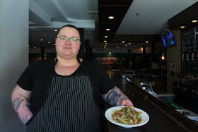 Chef Alyssa Dignard serves up some fries at Hopyard. She’s making two different burgers for two different restaurants for Burger Battles between April 13 and 23. George Melitides • The Guardian