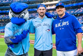 Toronto Marlies forward Logan Shaw of Glace Bay, middle, threw out the ceremonial first pitch prior to the Toronto Blue Jays' home game against the Tampa Bay Rays at Rogers Centre on Friday. PHOTO/TORONTO BLUE JAYS.