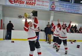 Wellington Flyers forward and team captain Jason Gallant hoists the championship trophy for the West Prince Senior Hockey League (WPSHL). The Flyers defeated the Kensington Granites 5-4 in the seventh and deciding game of the championship series before a full house at the Evangeline Recreation Centre on April 15. Jason Simmonds • The Guardian