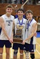 First cousins Oliver Rutherford, left, and Josh Aucoin hold the ACAA championship trophy with Sainte-Anne teammate Louis-Philippe LeBlanc, right, after the Dragons won the school’s first men’s volleyball conference championship in 26 years. CONTRIBUTED