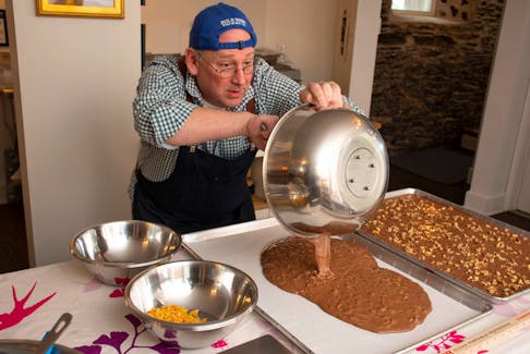 Marshall Parker, co-owner of Whim Chocolate and Frabjous Delights Specialty Foods, prepares a milk chocolate with mango and habanero bar at his shop at the intersection of Agricola and Roberts streets in Halifax on Monday, April 17, 2023. - Ryan Taplin - The Chronicle Herald
