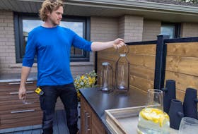 Michael putting the final touches on a new outdoor kitchen for a homeowner's reveal on Holmes Family Rescue. 